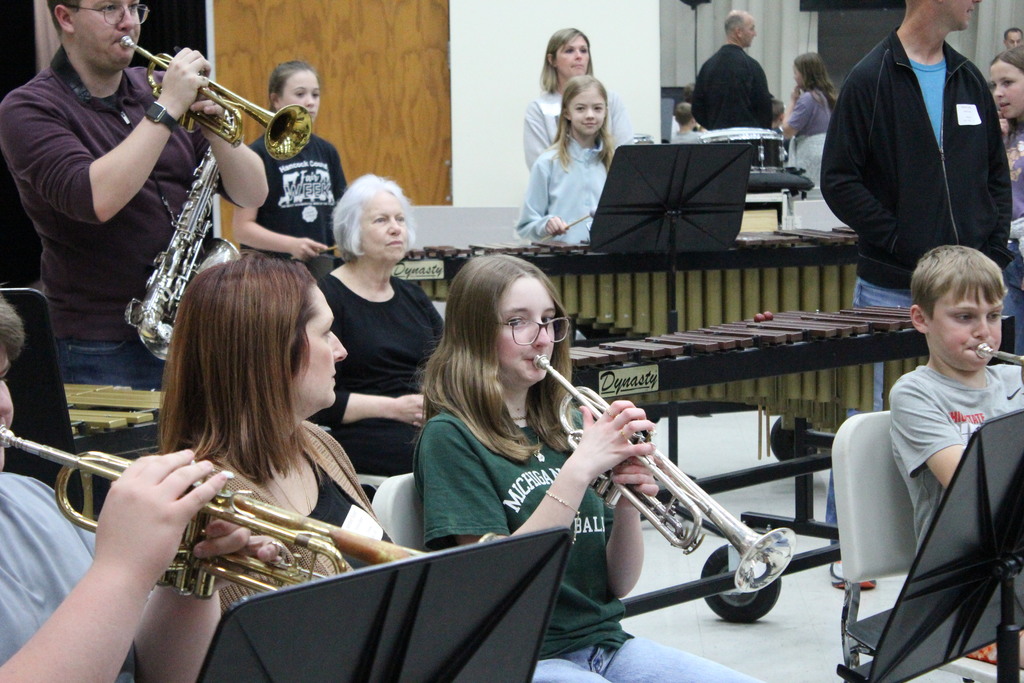 Family members watch their students play their instruments during band.