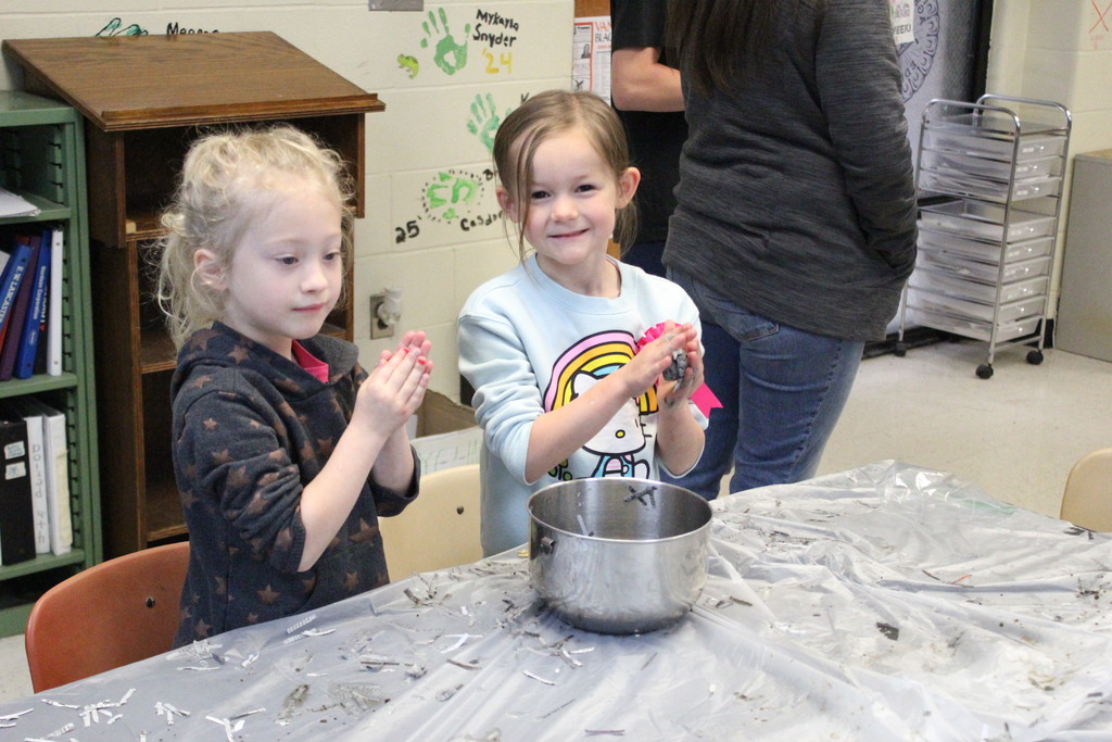 Two students make their seed pods.