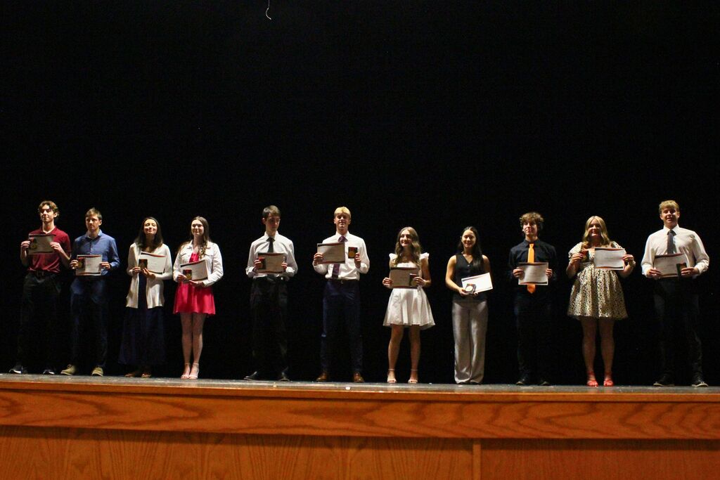 The students graduating with a 4.0 GPA are recognized onstage and receive their certificates and medals to wear at graduation.