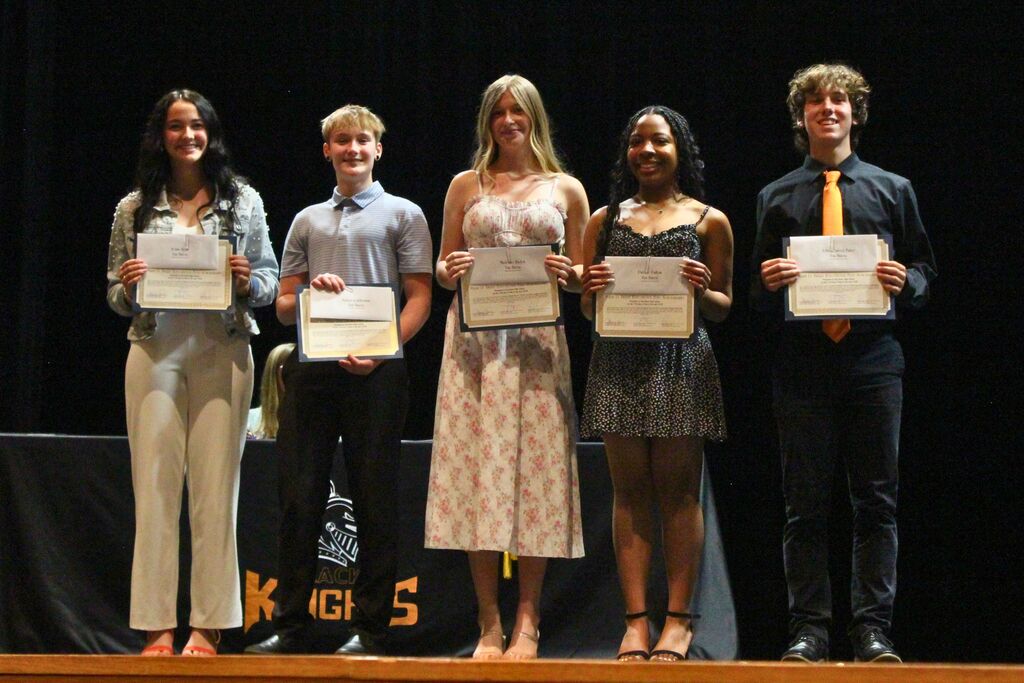 Students pose with their certificates after being awarded the Marie Berry Scholarship.