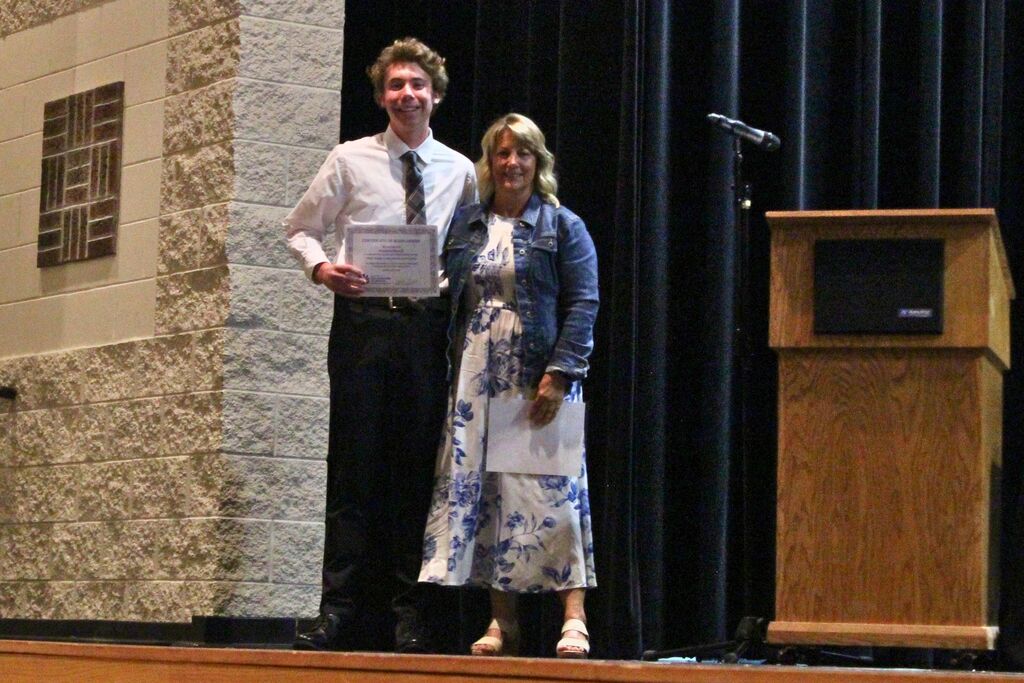 Brandon, winner of the Officer Douglas T. Akers Memorial Scholarship, poses with Vaughn Akers.