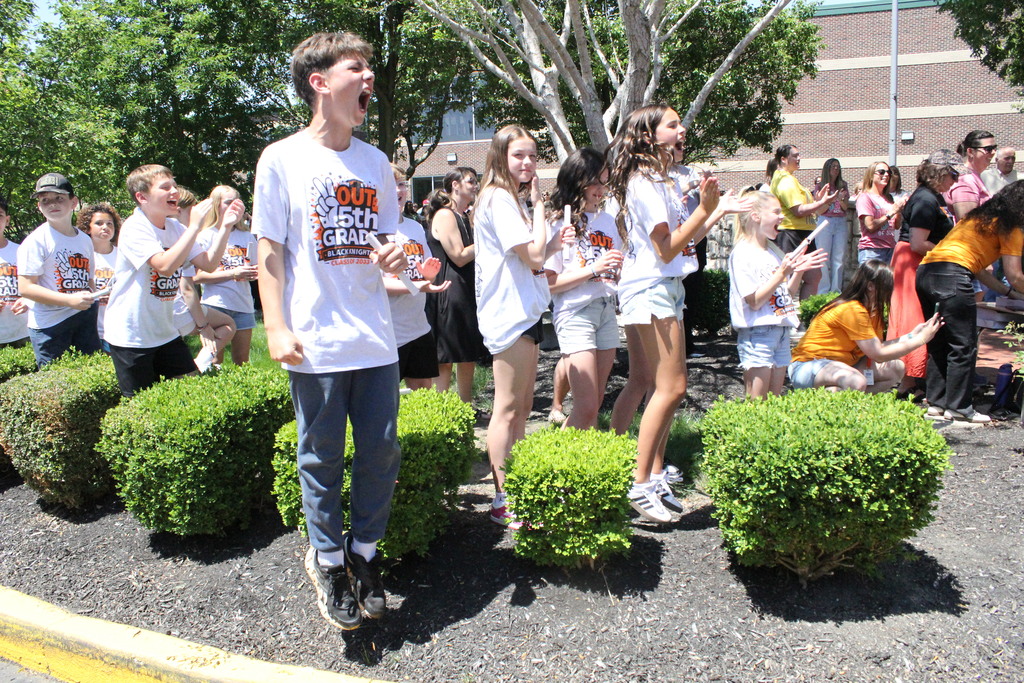 Fifth graders who have already crossed the bridge cheer for their classmates.