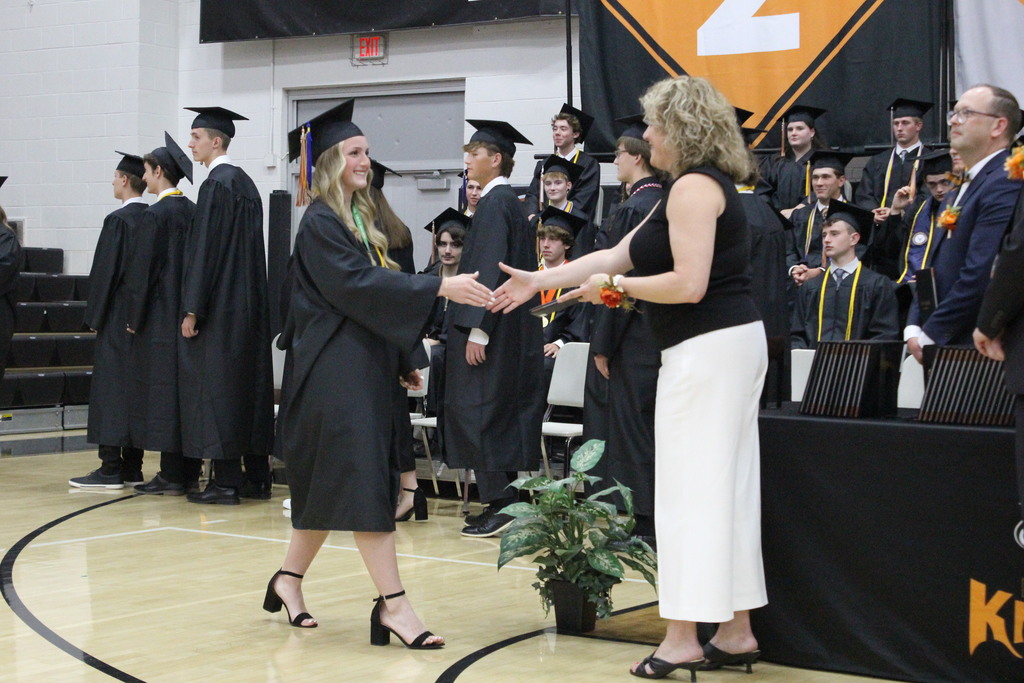 Kami Bowman receives her diploma from Board of Education President Mrs. Laura Ebright.