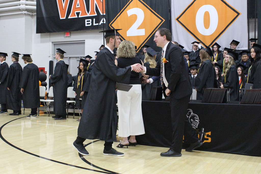 Aiden Businger is congratulated by Dr. Inkrott after receiving his diploma.