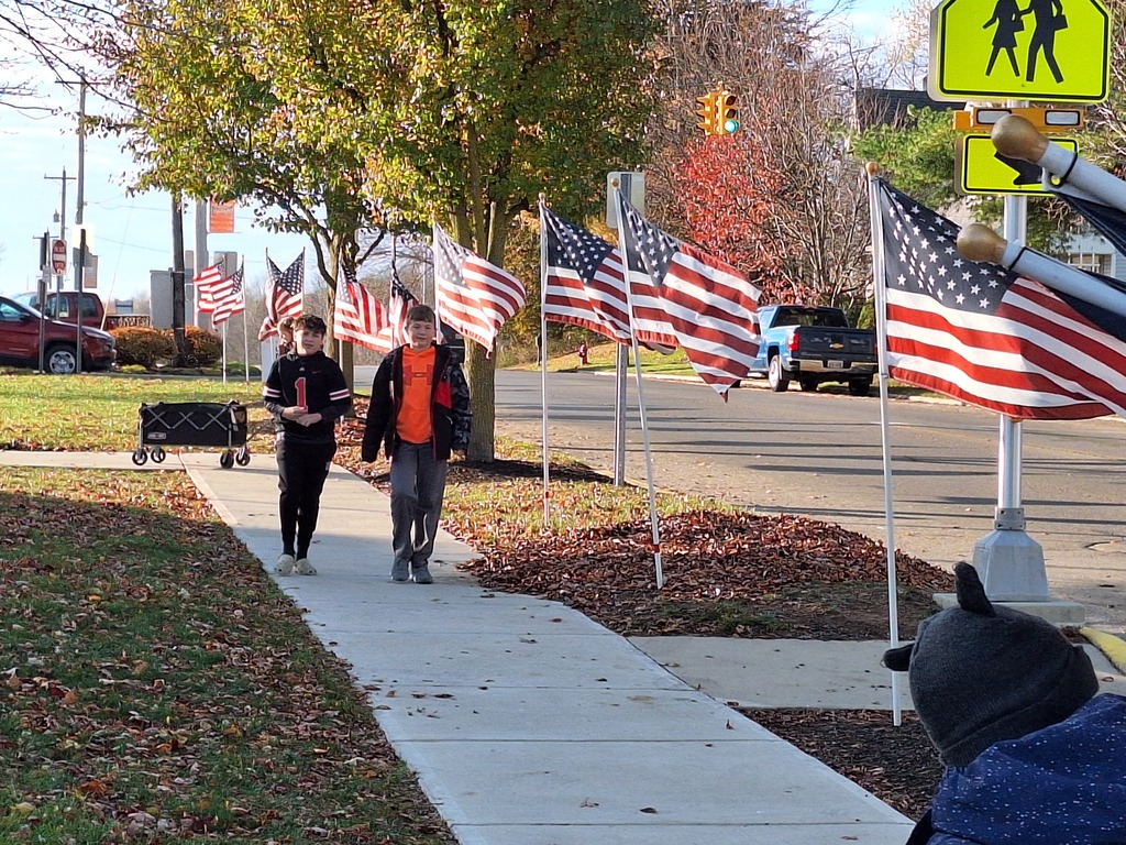 Students prepare to help take down the flags in the fall.