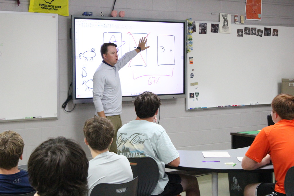 A picture showing Mr. Carter working through a problem with his students.
