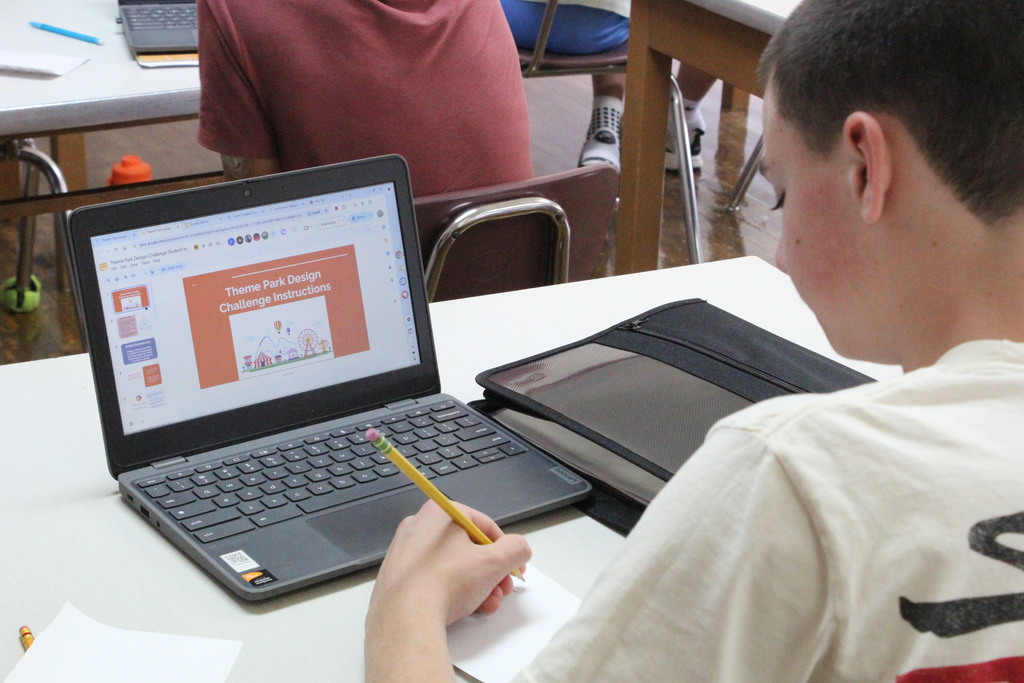 A picture showing a student beginning to iterate a design for the Theme Park Design Challenge.