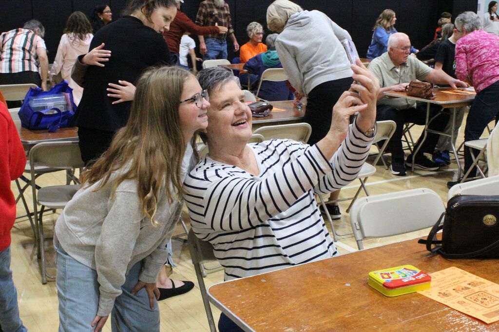 A picture of a student and VIP taking a selfie at the event.