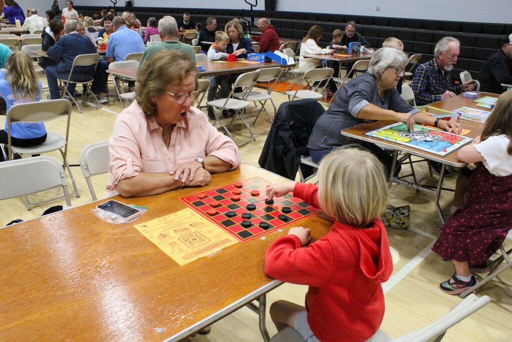 A picture showing a student and VIP playing checkers.