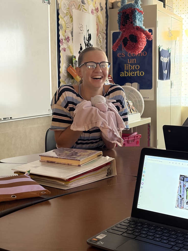 A picture of a CCP Spanish III student posing with a stuffed animal.