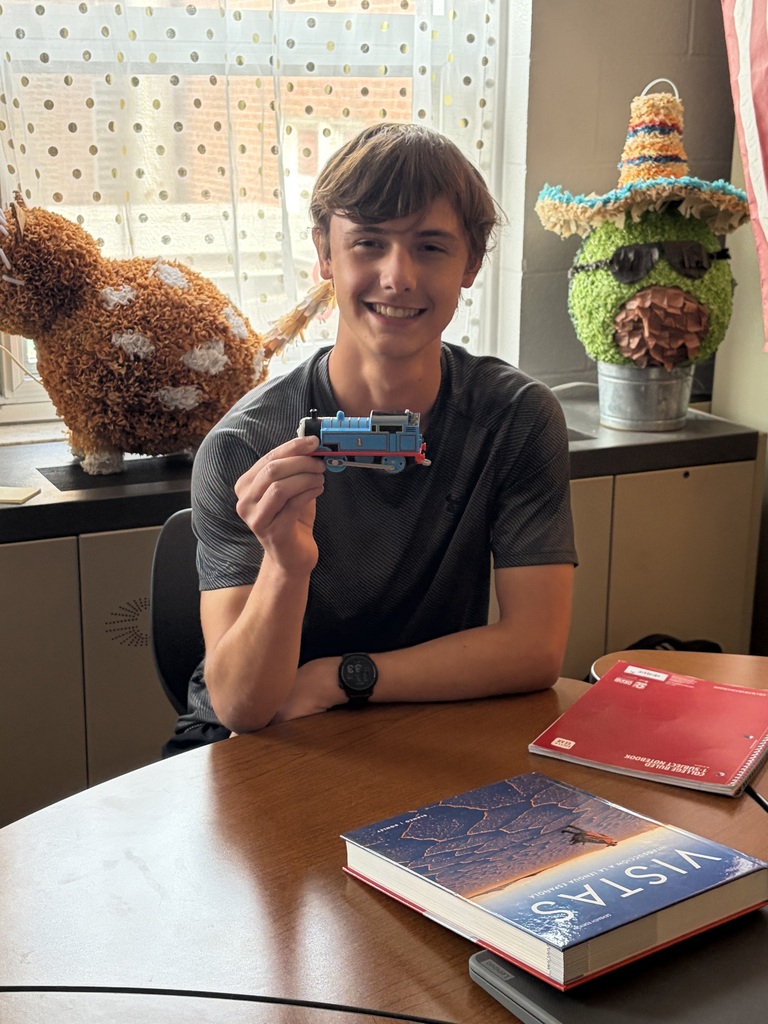 A picture of a CCP Spanish III student posing with a Thomas the Train toy.