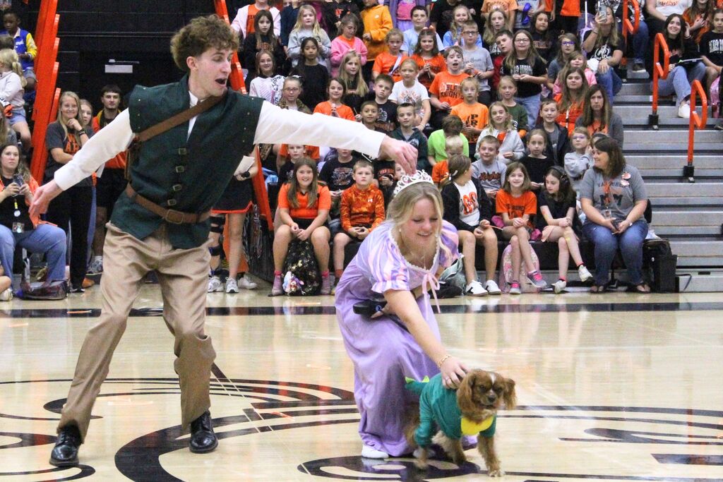 A picture of two homecoming court attendants being introduced at the pep rally.