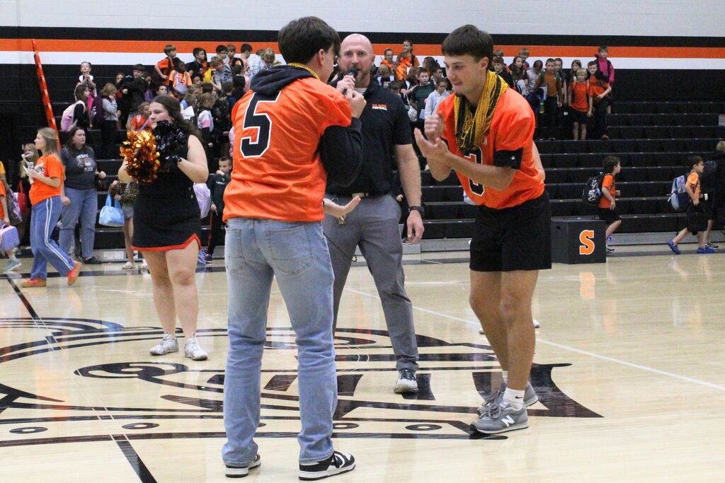 A picture of two students competing in the semifinals of the rock, paper, scissors battle.