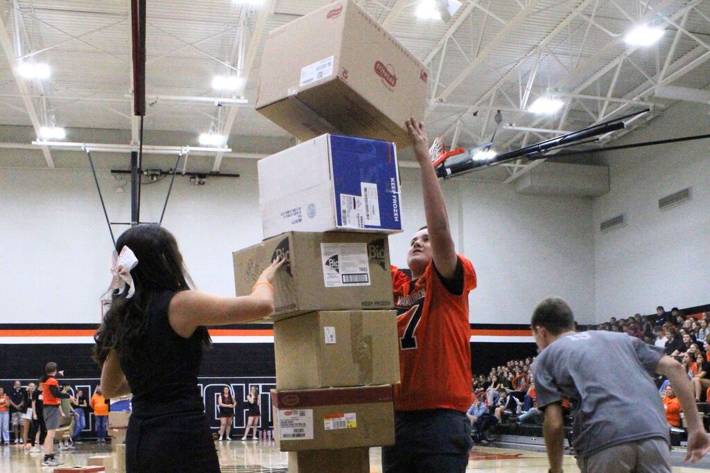 A picture of a student stacking boxes for one of the pep rally games.