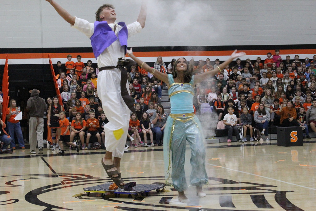 A picture of two homecoming court attendants being introduced at the pep rally.