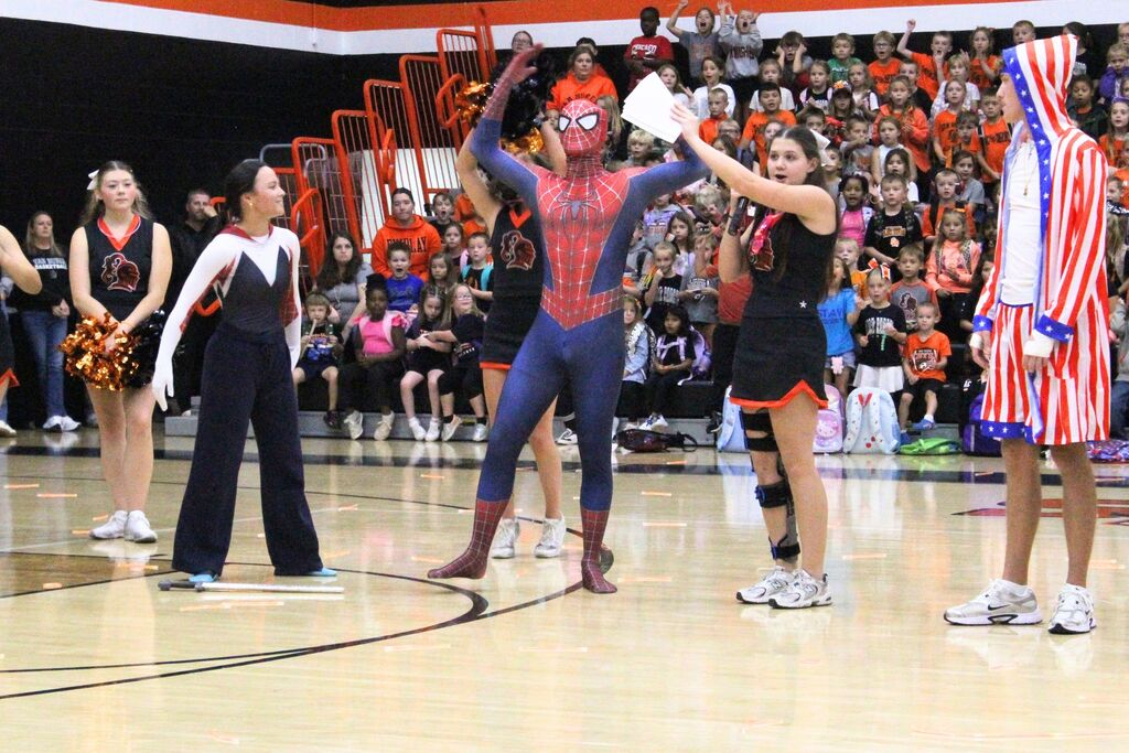 A picture of two homecoming court attendants being introduced at the pep rally.