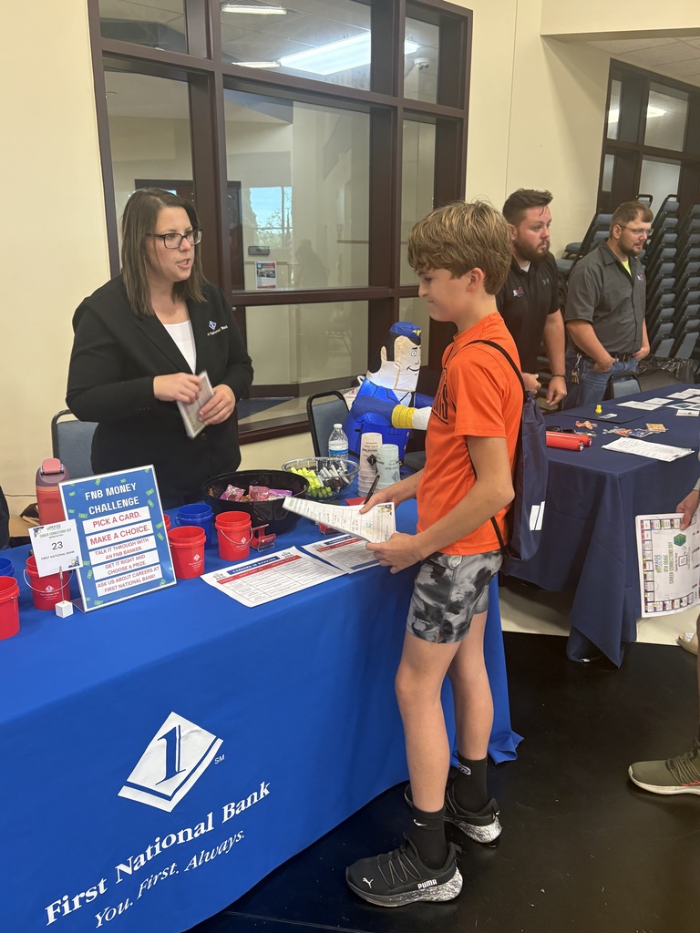 A picture of a student talking to a representative from First National Bank about career opportunities.