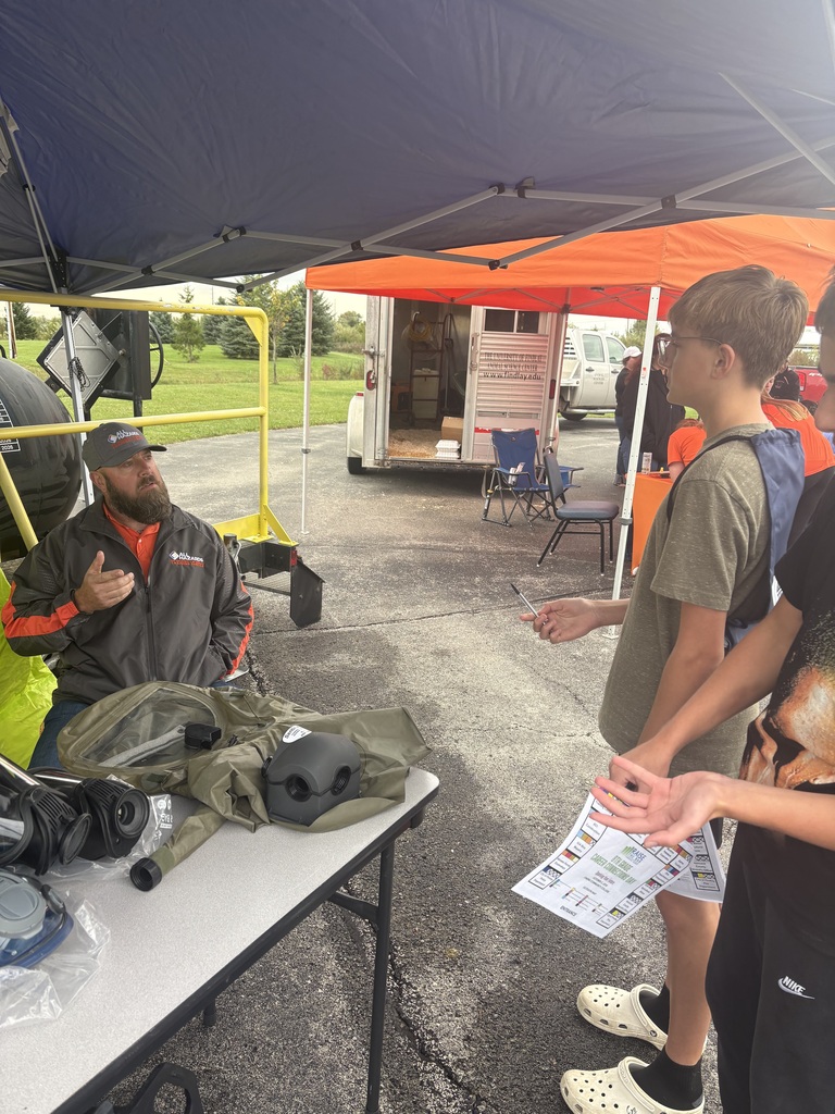 A picture of a student talking to a business representative about career opportunities.