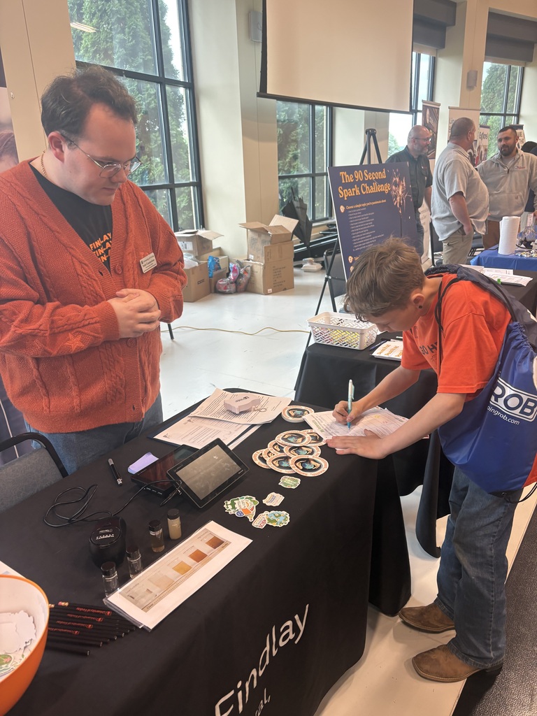 A picture of a student talking to a representative from the University of Findlay about career opportunities.
