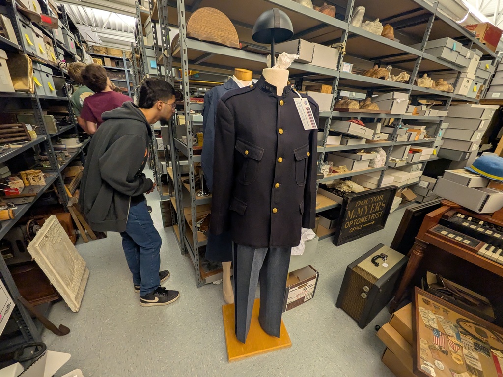 Students look at some of the artifacts found in the museum archives.