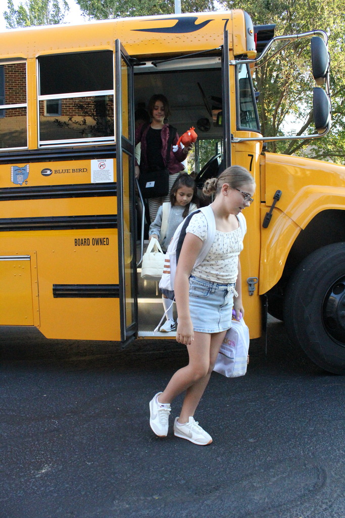 A picture of students exiting the bus on the first day of school.