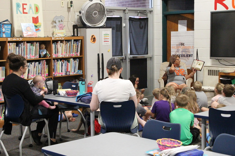 Summer Read participants listen to elementary librarian Mrs. Tammy Routson as she reads to them.