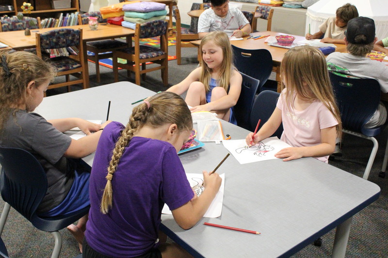 Students work on coloring at Summer Read.