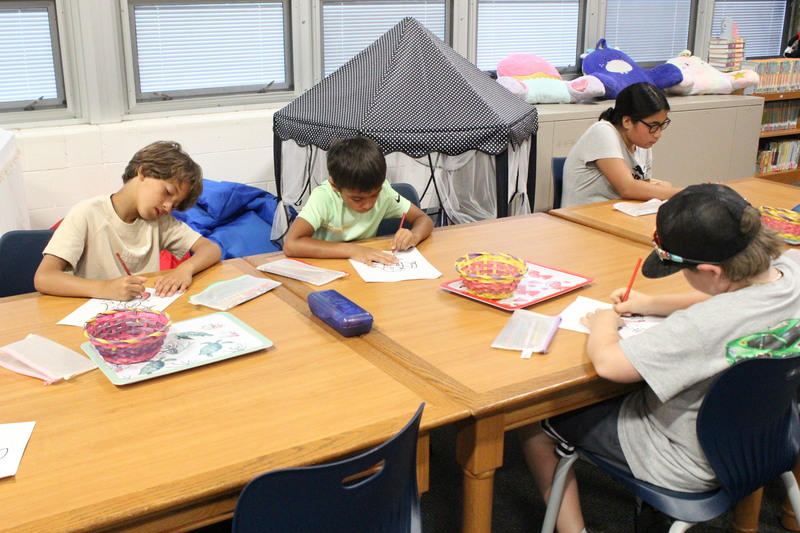 Students work on coloring at Summer Read.