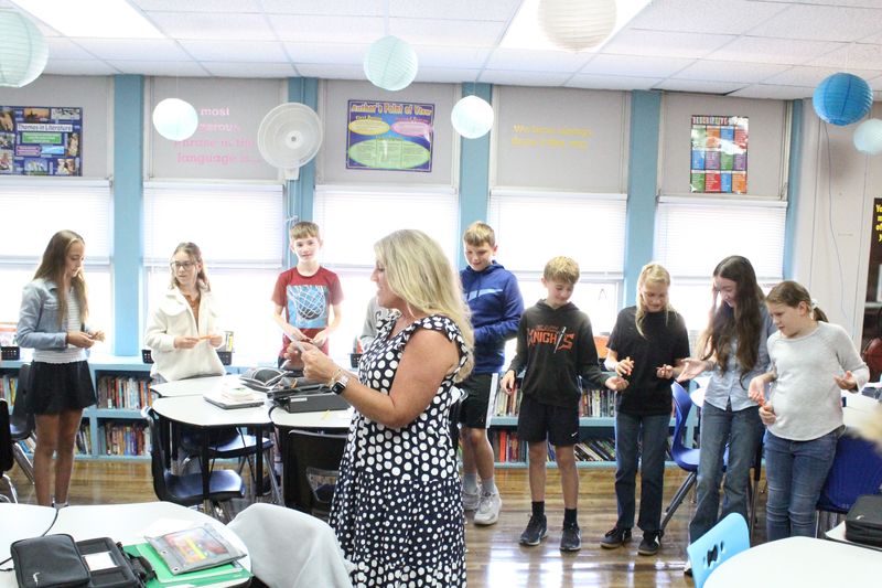 Middle school students participate in a listening activity on the first day of school