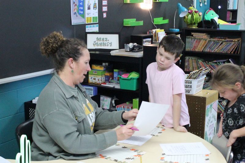 Mrs. Cassi Swaney assists a student.