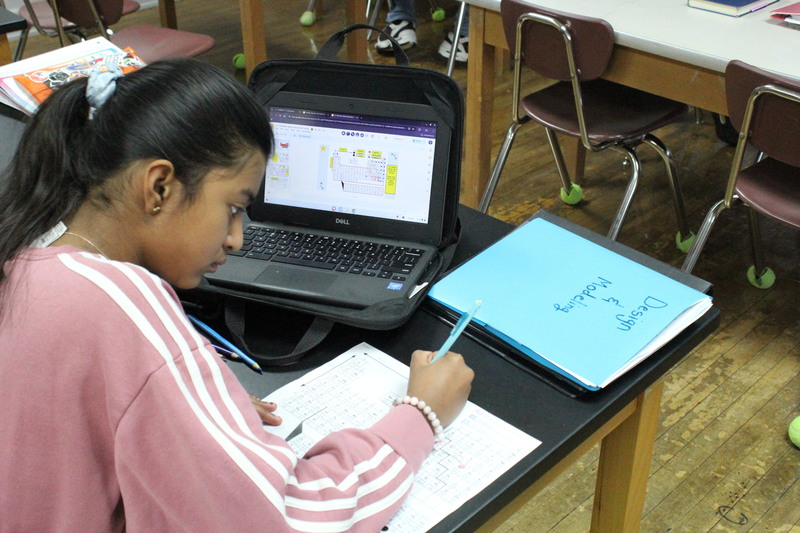 A student works on an assignment pertaining to the periodic table.