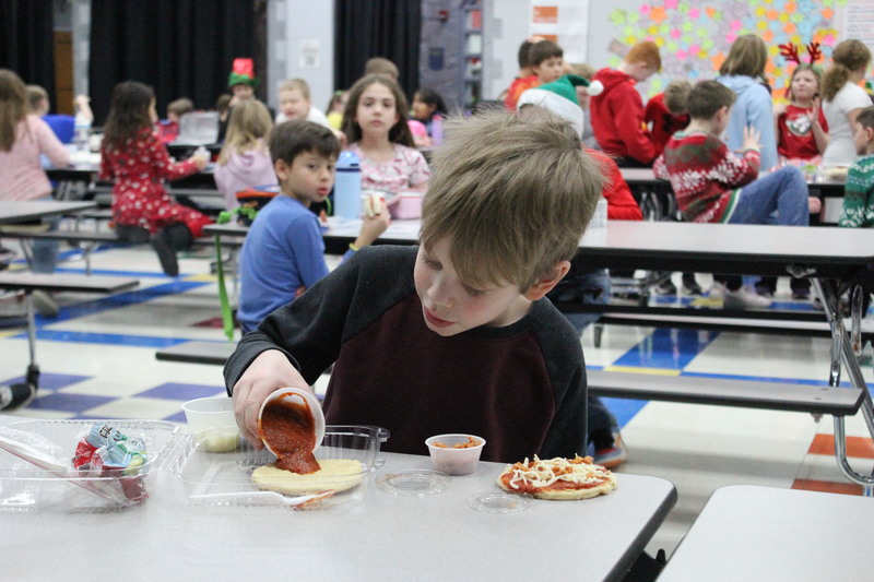 A student eats one of the grab-and-go lunches.
