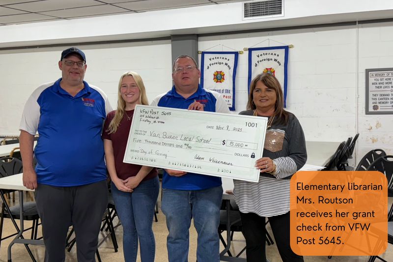 Elementary librarian Mrs. Routson receives her grant check from VFW Post 5645.