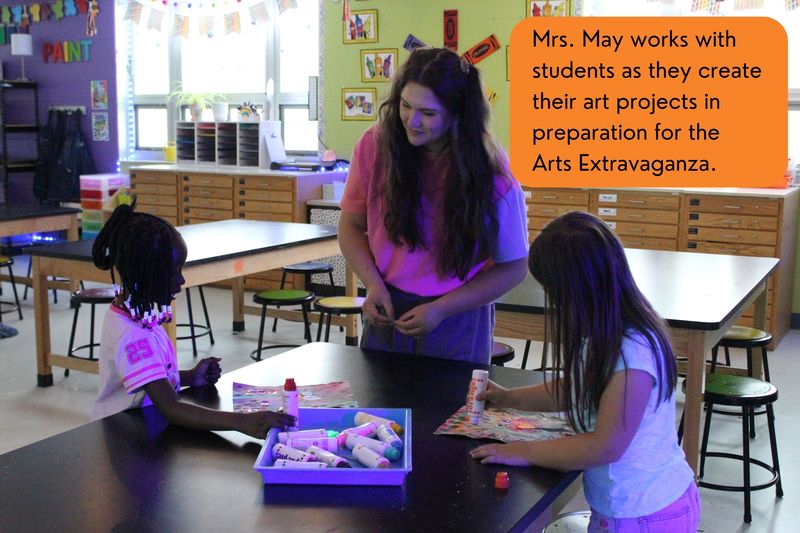 Mrs. May works with students as they create their art projects in preparation for the Arts Extravaganza.