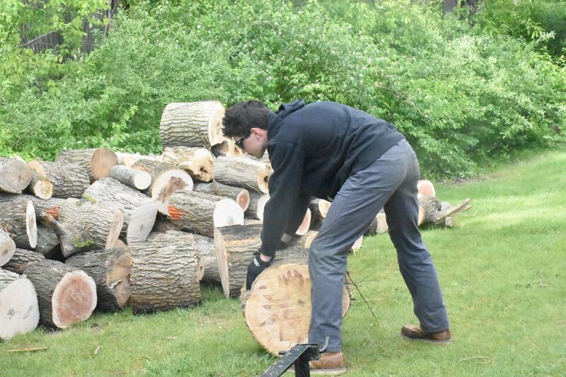 Trace moves wood in the vicinity of the soccer field.