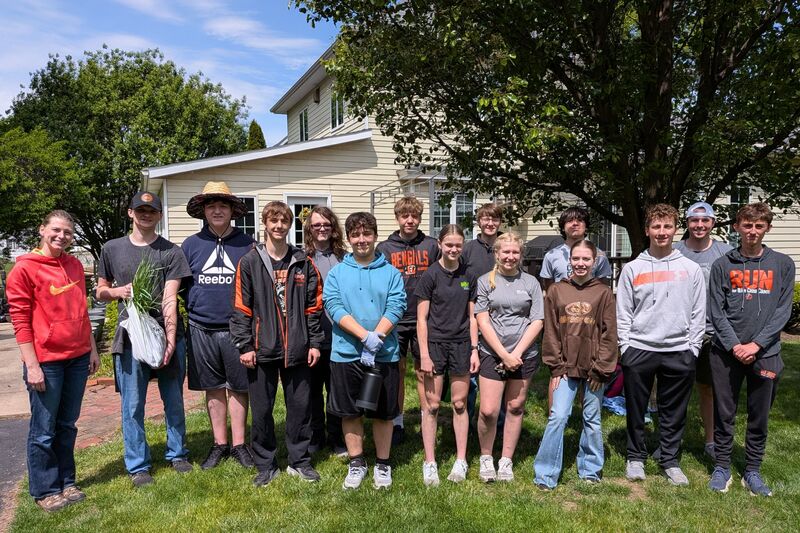 A group poses after completing a service project.