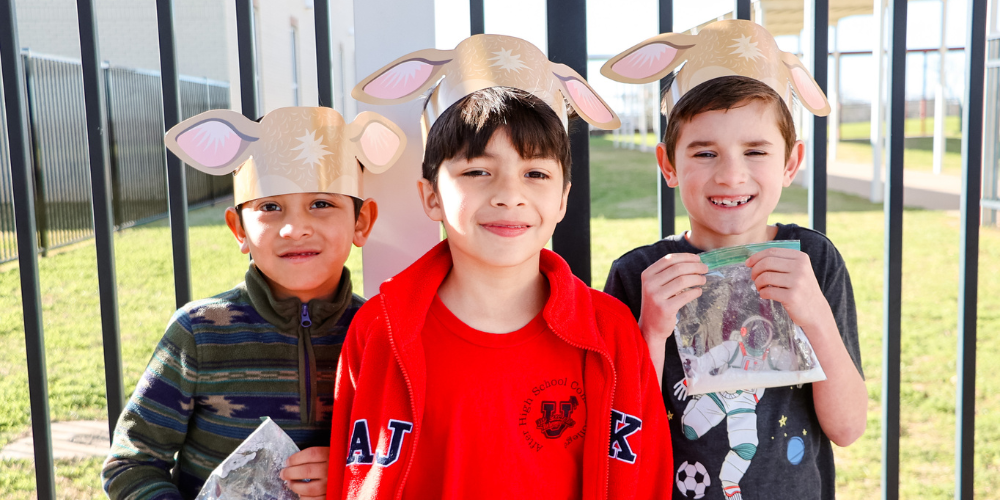 three students with cow-ear shaped crowns on their head