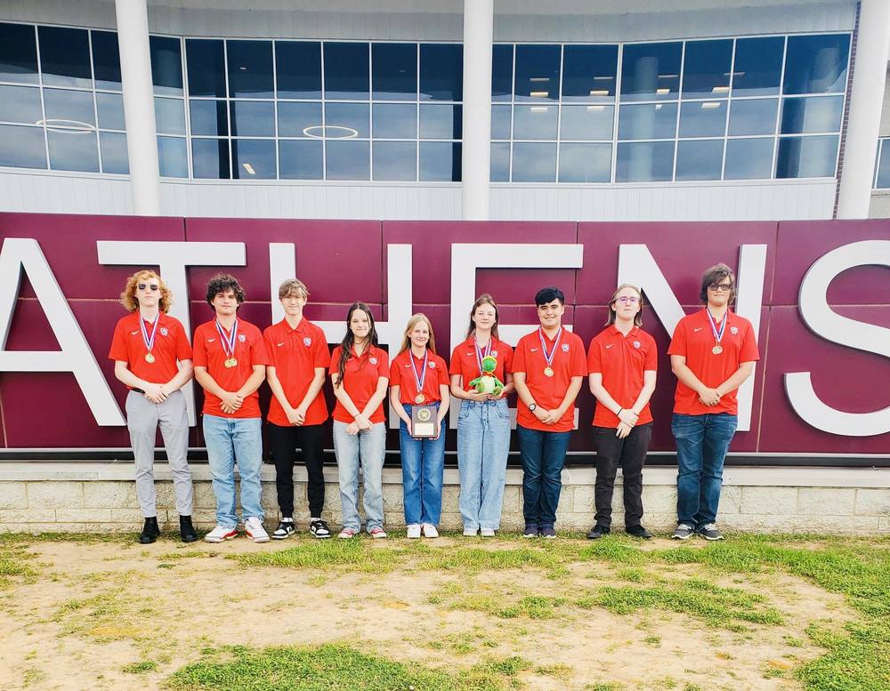 uil social studies team poses in a line together after a win