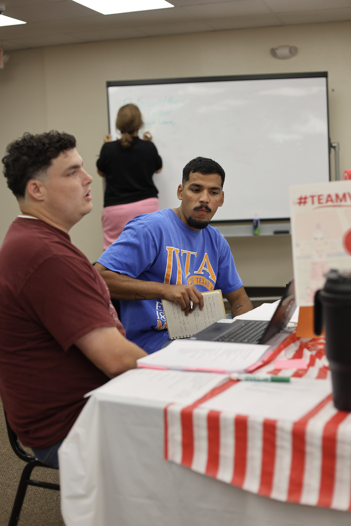 two men at a table collaborating