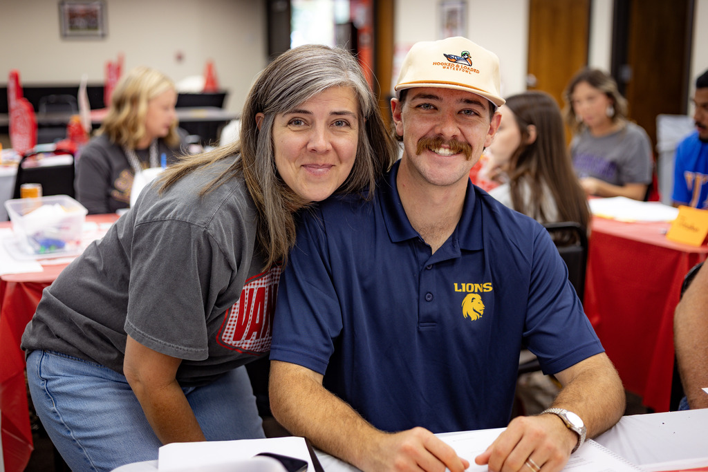 mother and son at a table smiling