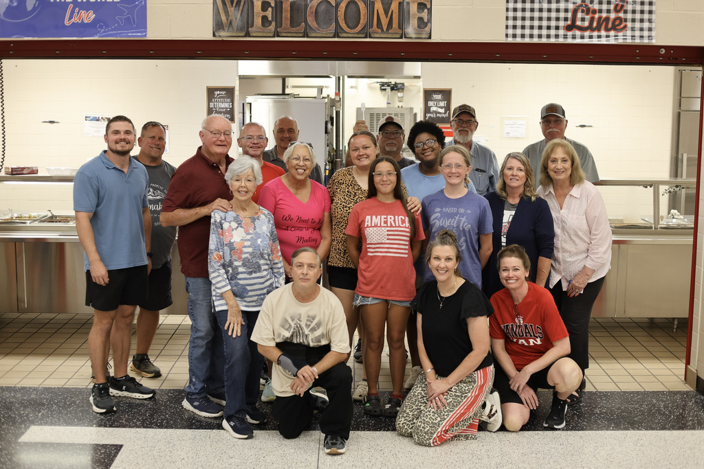Group photo of adults in a cafeteria