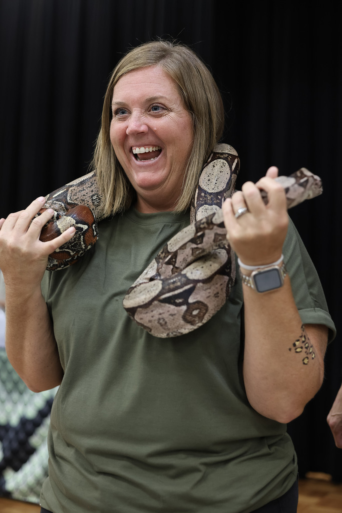 Woman holding a large snake