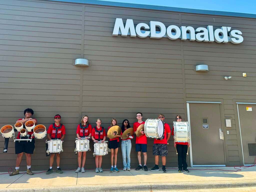 HIGH SCHOOL STUDENTS STANDING OUTSIDE MCDONALD'S