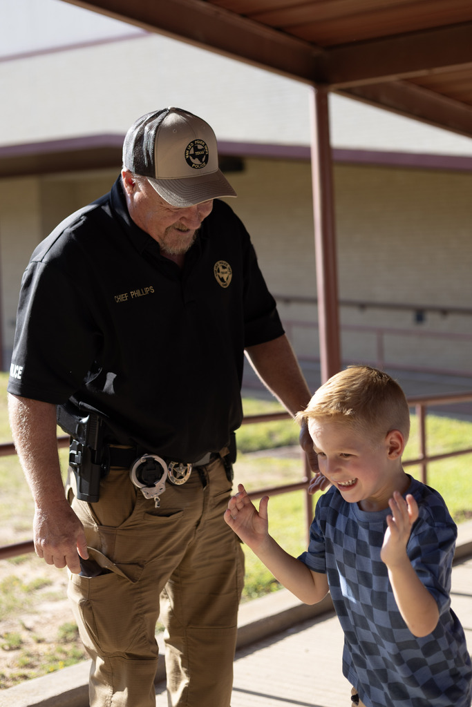 Officer and small boy smiling at each other