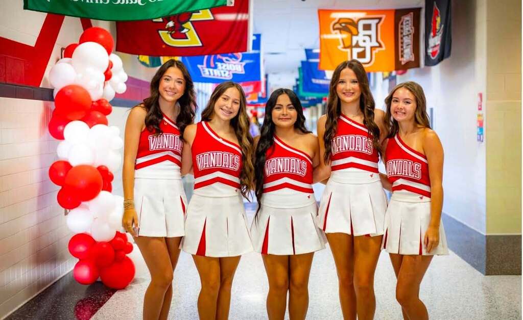 5 cheerleaders in a school hallway