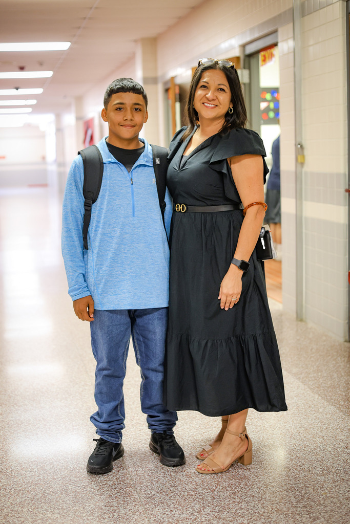 adult and student in a school hallway