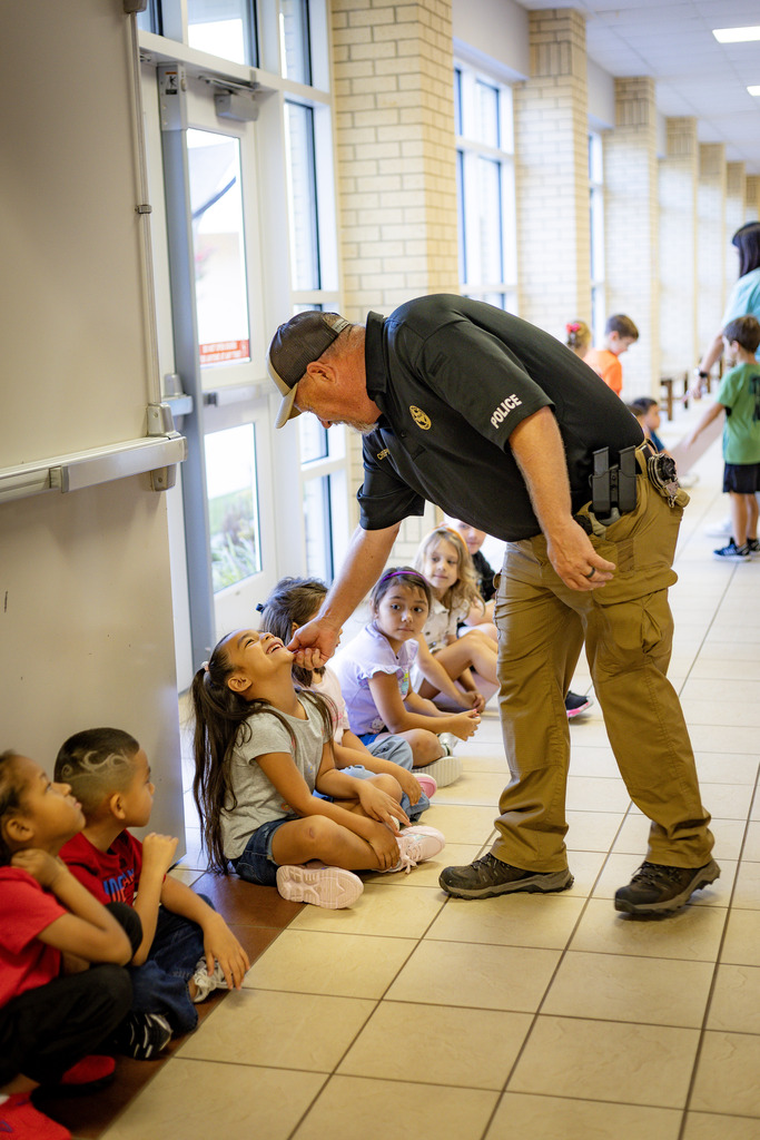 students in a hall way with a safety officer