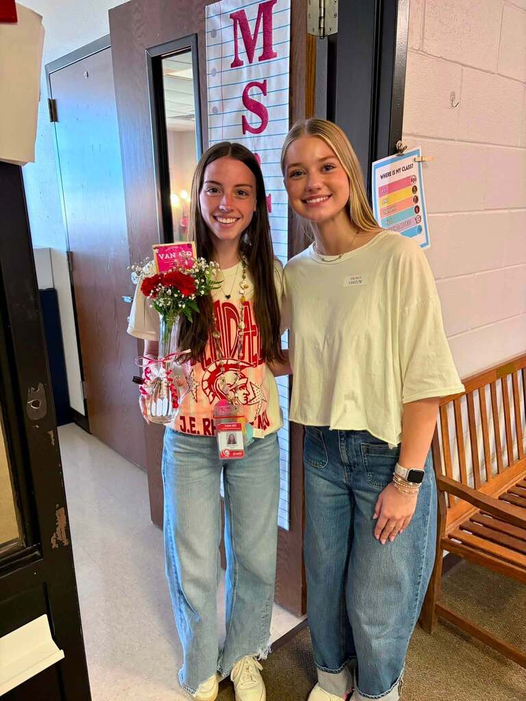 teacher receiving flowers from student