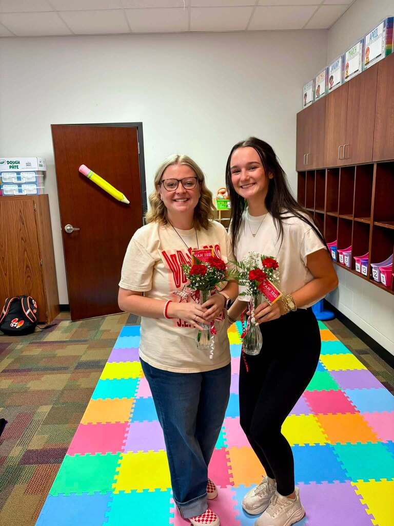 teacher receiving flowers from student