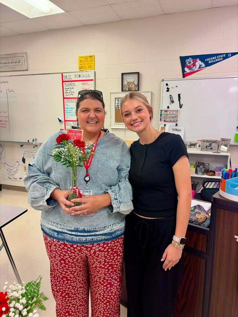 teacher receiving flowers from student